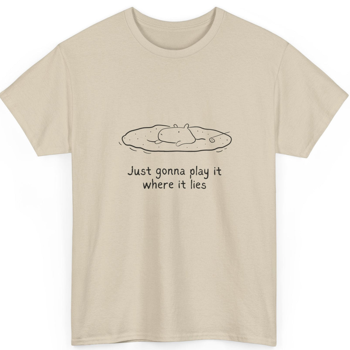 Beige t-shirt with a graphic of a capybara in a sand bunker and the text "Just gonna play it where it lies" on a white background