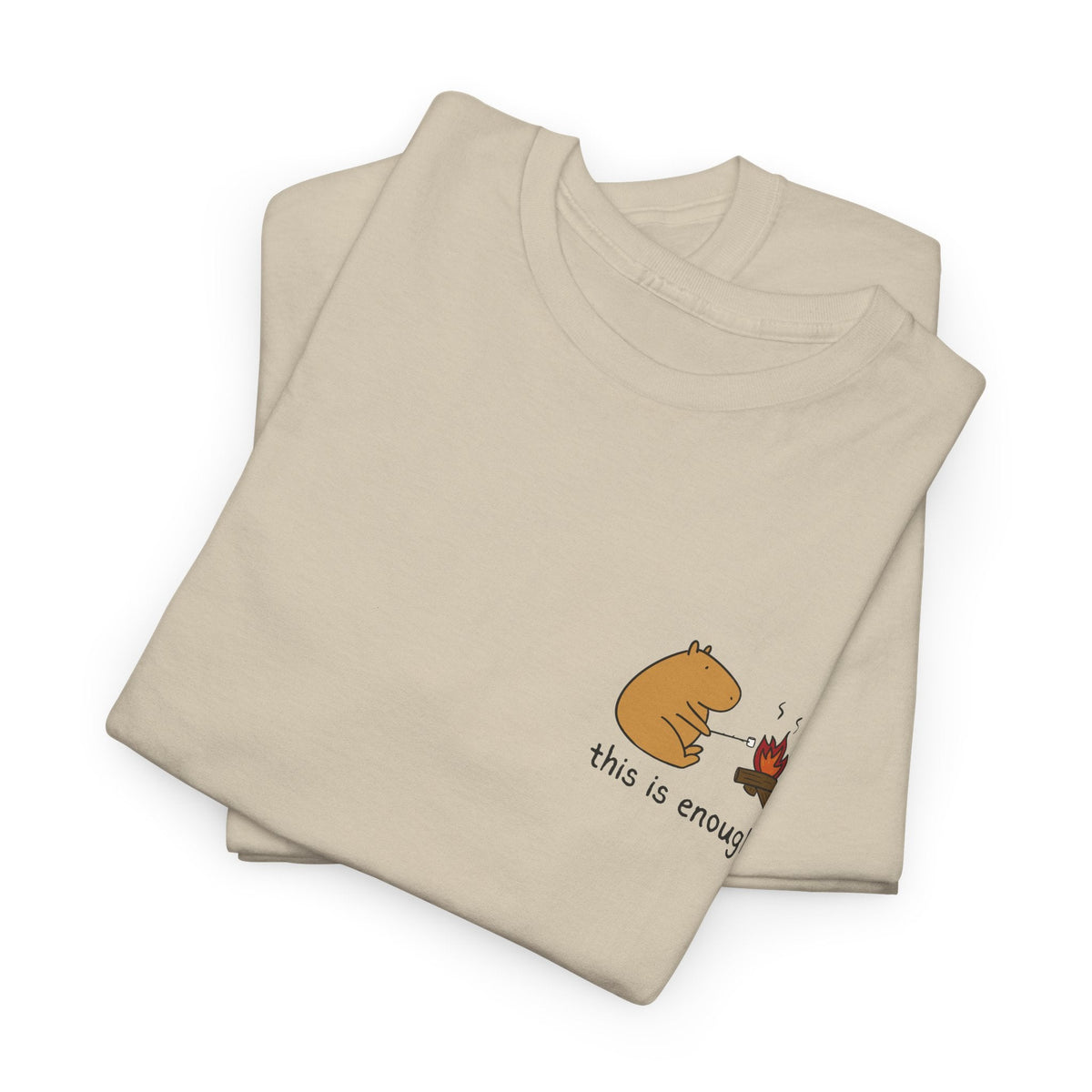 Capy Life heavyweight beige t-shirt with a small left-chest graphic of a capybara roasting a marshmallow by a fire.