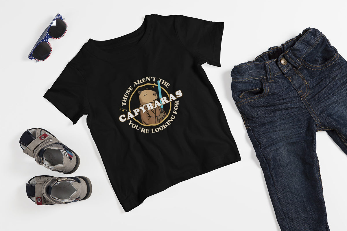 Capy Life black youth t-shirt featuring a comic-style Jedi capybara graphic with a lightsaber and Star Wars parody text.