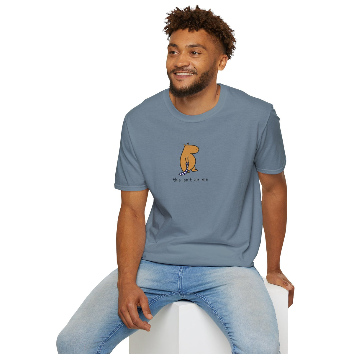 A man wearing a Capy Life blue heavyweight cotton t-shirt with a hand-drawn capybara graphic and text this isnt for me