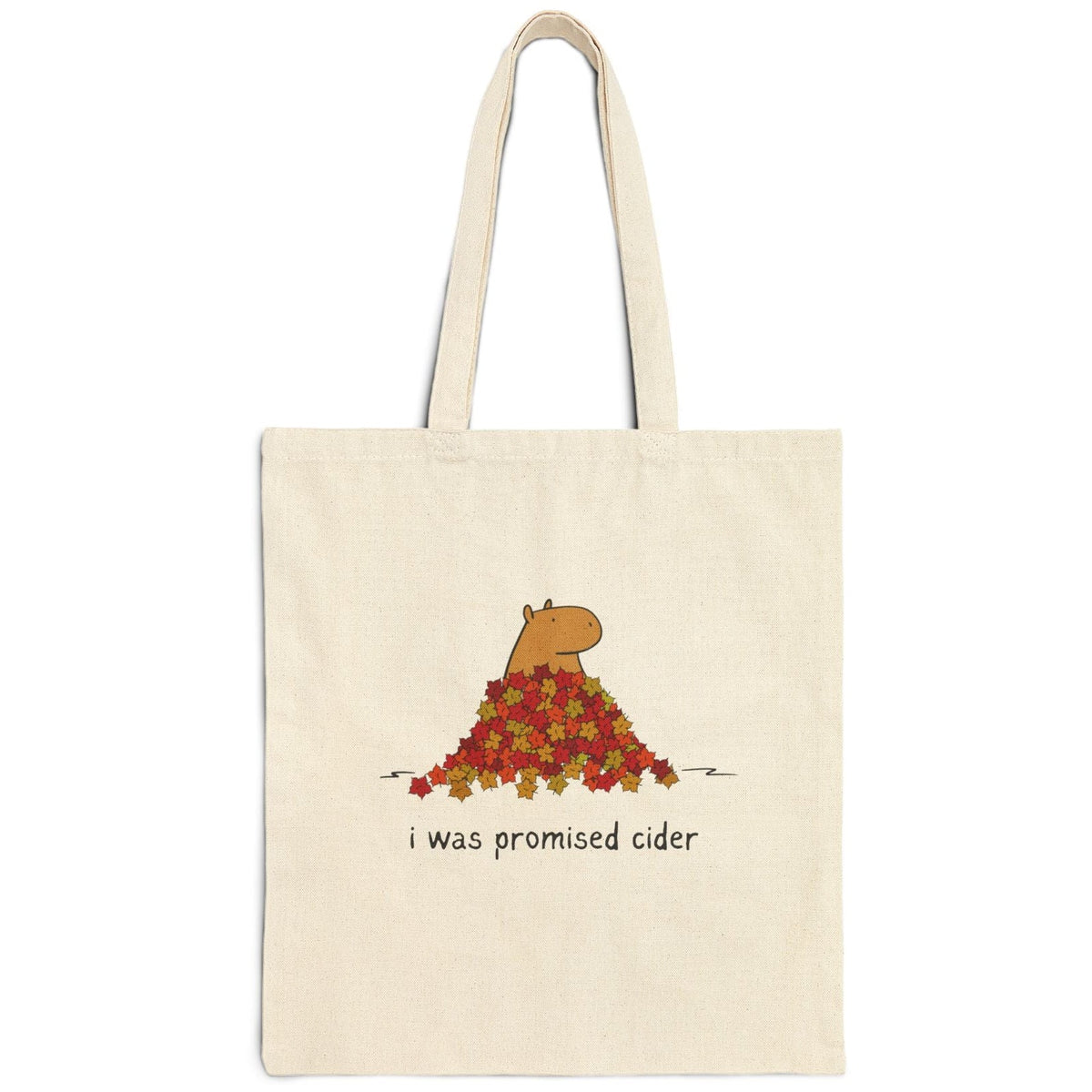 Capy Life natural canvas tote bag featuring a capybara in autumn leaves with the text I was promised cider