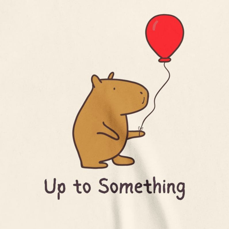 Capy Life youth tee featuring a cute capybara holding a red balloon with the text Up to Something
