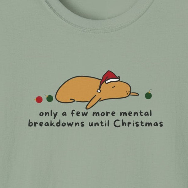 Capy Life softstyle tee featuring a tired capybara in a Santa hat with the text only a few more mental breakdowns