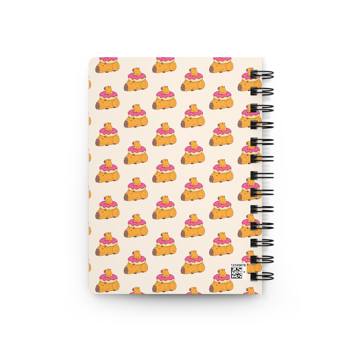 Capy Life spiral notebook featuring a repeating pattern of cute capybaras with pink frosted donuts on a cream background.