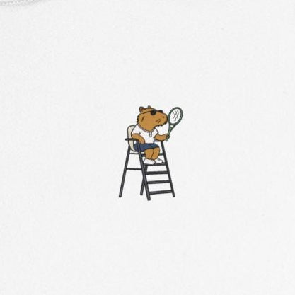 Capy Life kids performance tennis shirt featuring a small graphic of a capybara umpire holding a racquet