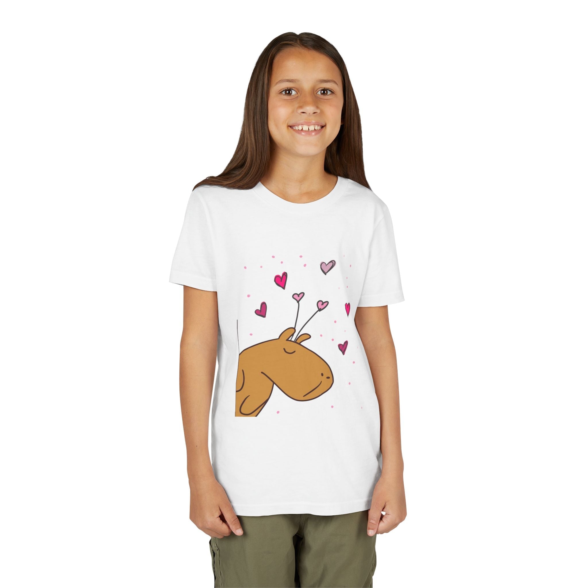 A young girl wearing a white Capy Life cotton t-shirt featuring a cute Gene the Capybara Valentine heart graphic.