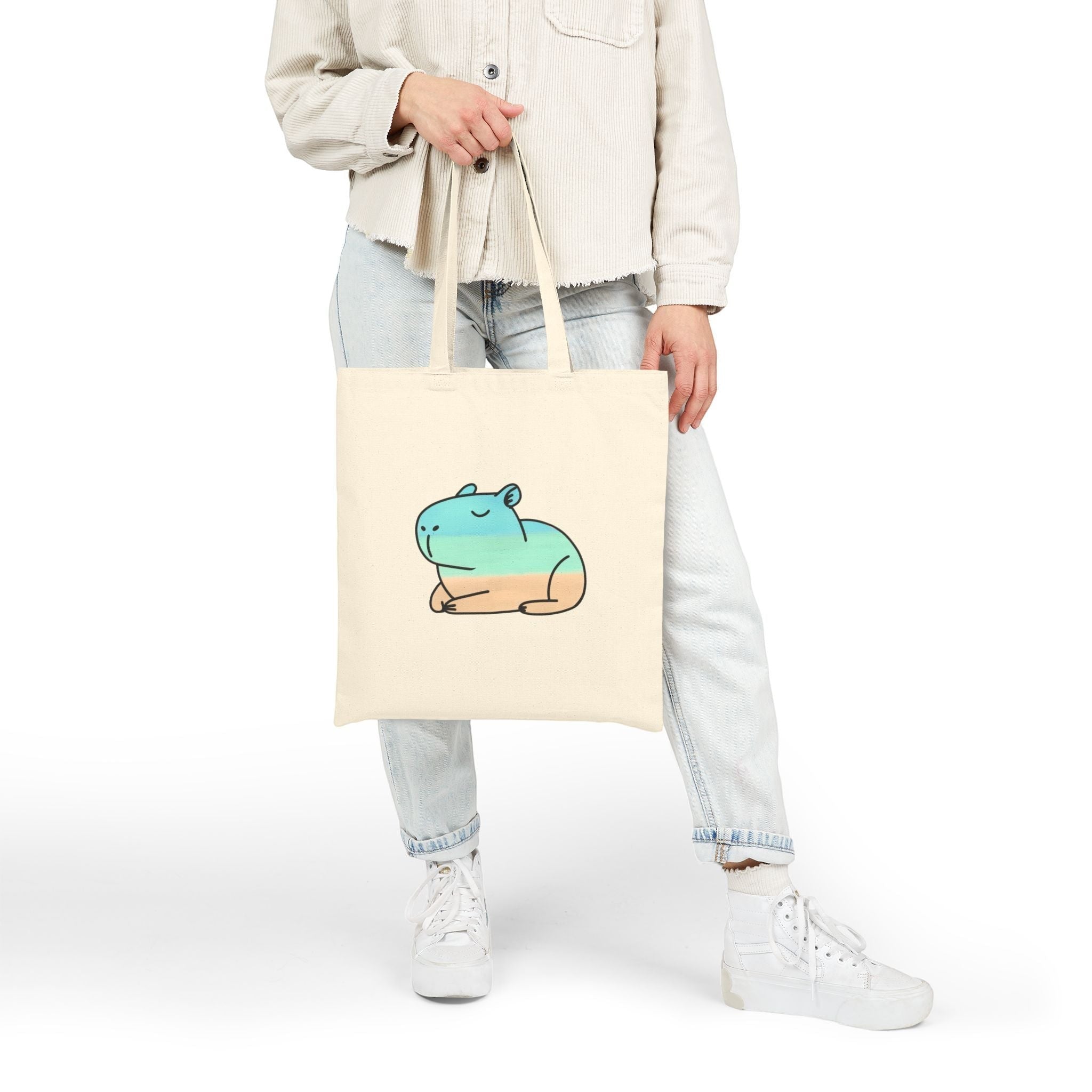 Capy Life natural cotton canvas tote bag featuring a minimalist hand-painted capybara in soft coastal beach tones.