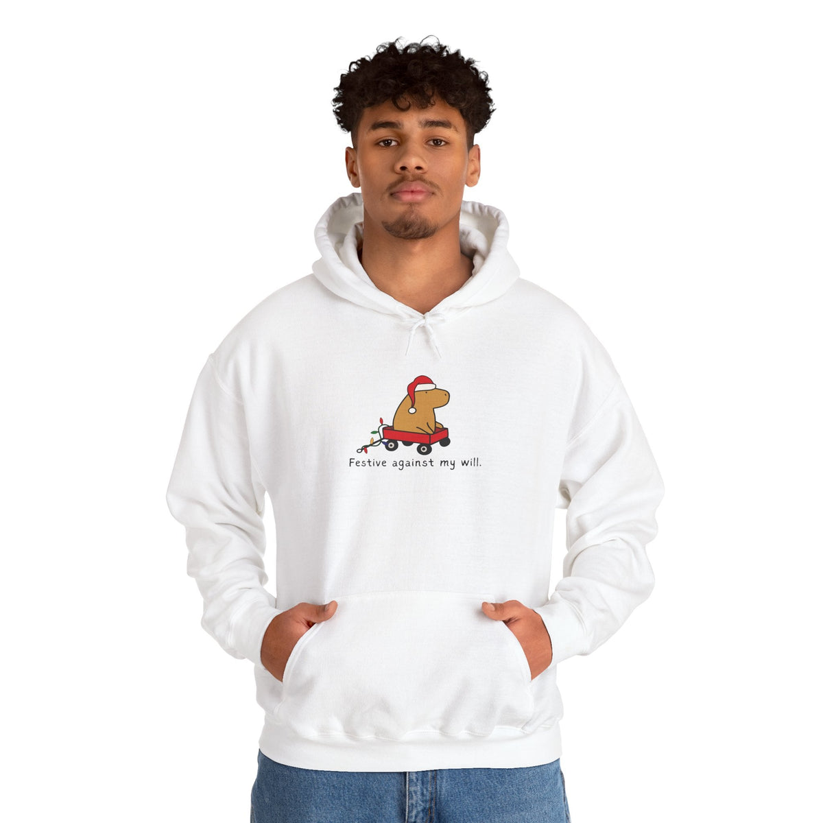 Capy Life white hoodie featuring a graphic of a capybara in a red wagon with a Santa hat and text Festive against my will