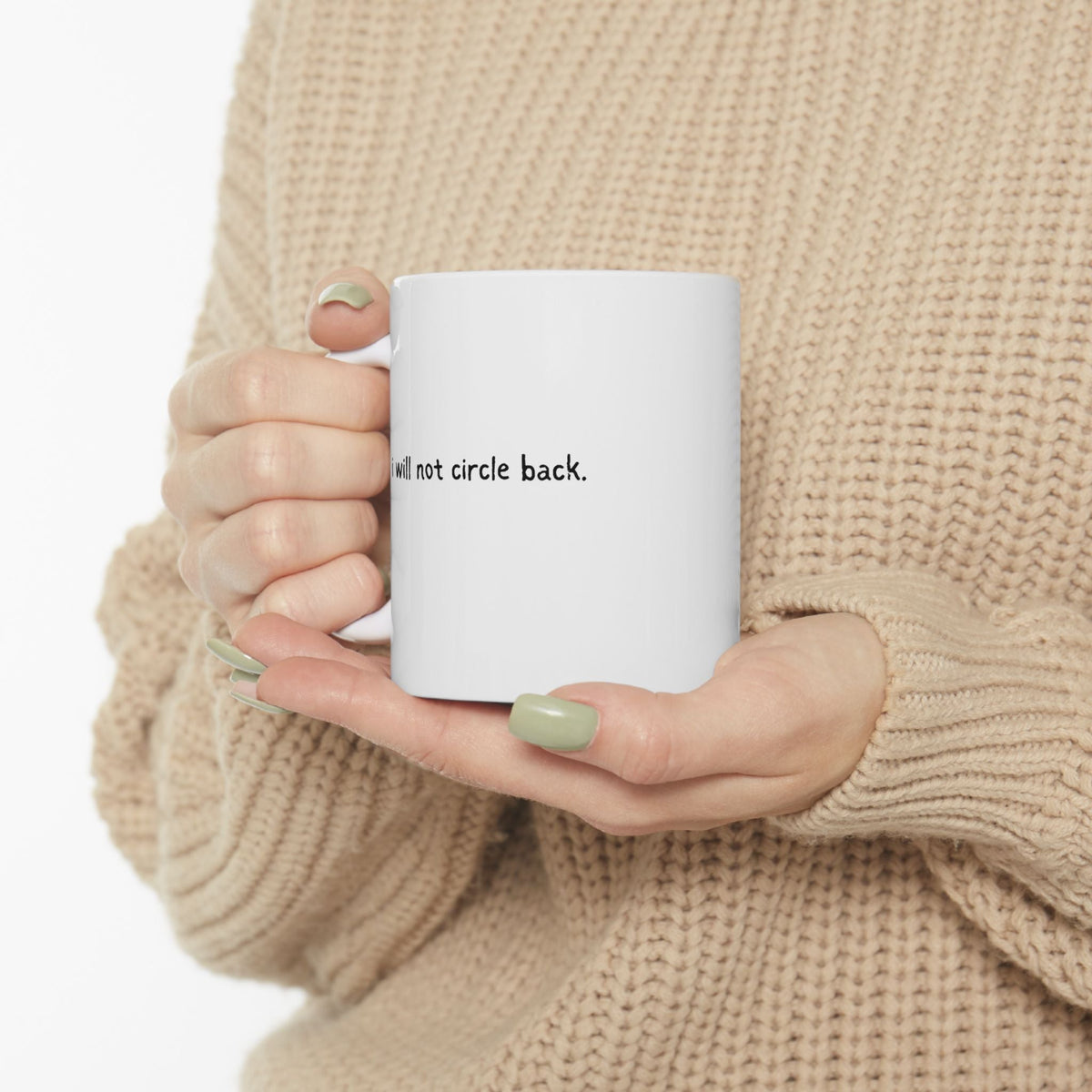 Capy Life white ceramic mug held by hands in a beige sweater, featuring the text I will not circle back in black.