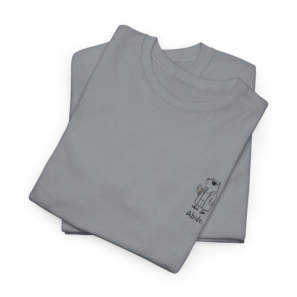 Capy Life grey heavy cotton t-shirt featuring a small left chest graphic of a capybara in a robe with the word Abide.