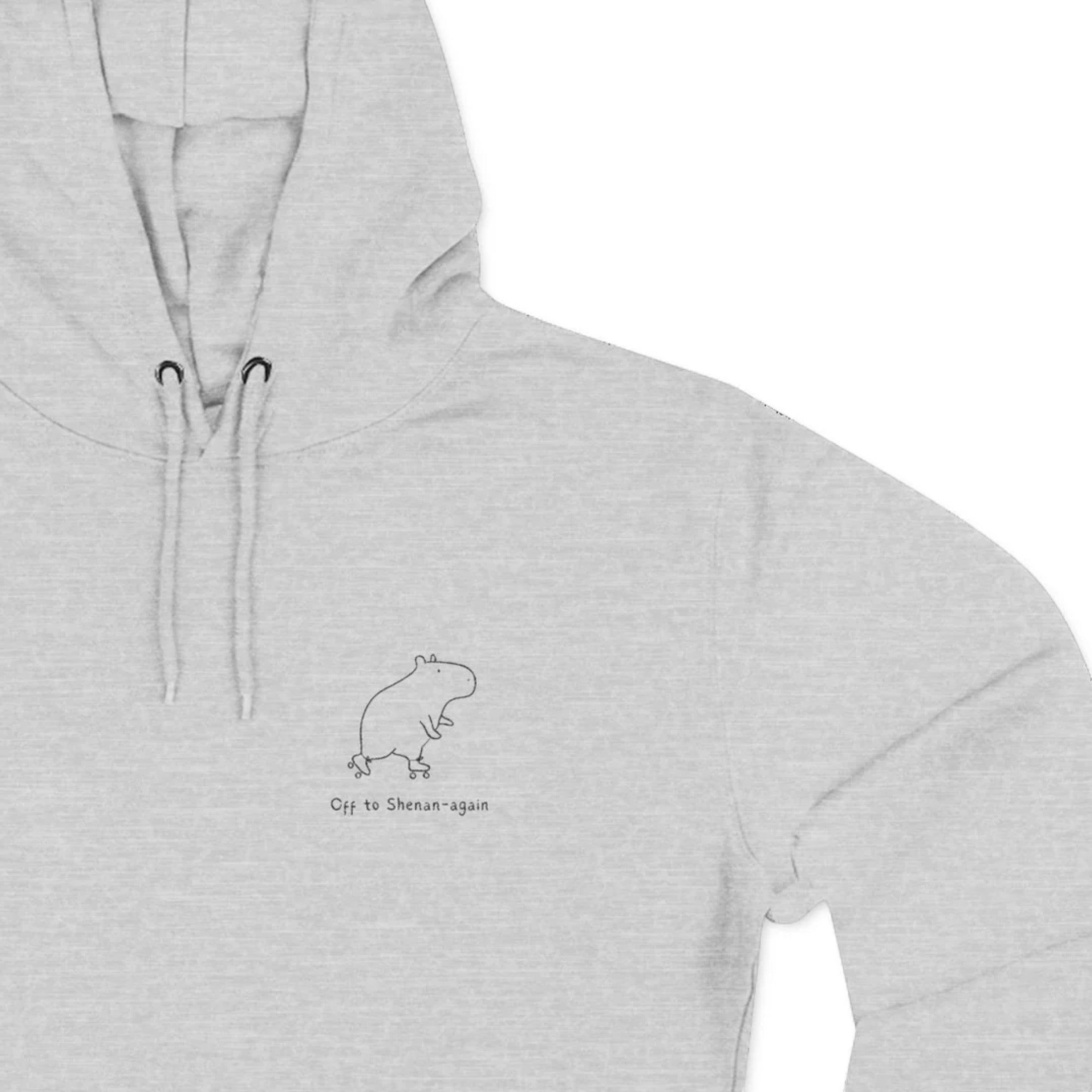 Capy Life grey fleece hoodie featuring a minimalist embroidered capybara and the text Off to Shenan-again.