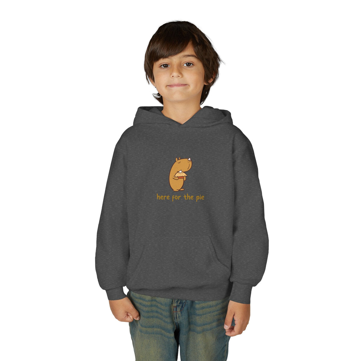 A young boy wearing a dark grey Capy Life kids hoodie featuring a cute capybara holding a slice of pie.