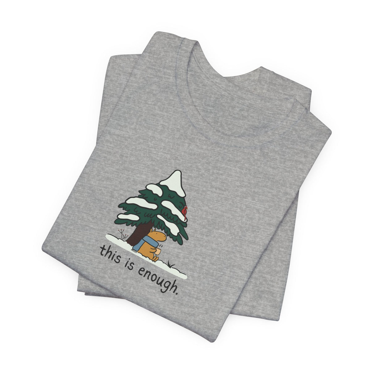 Capy Life grey graphic t-shirt featuring a hand-drawn capybara in a blue scarf under a snowy evergreen tree.