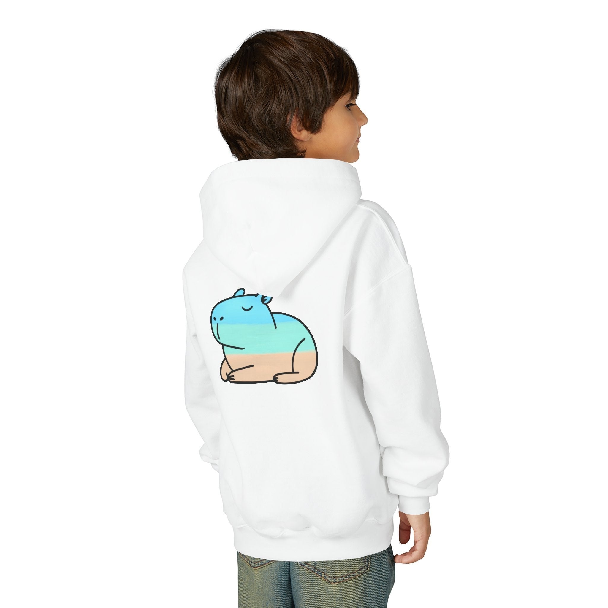Child wearing a white Capy Life kids hoodie featuring a playful blue and tan beach capybara graphic on the back