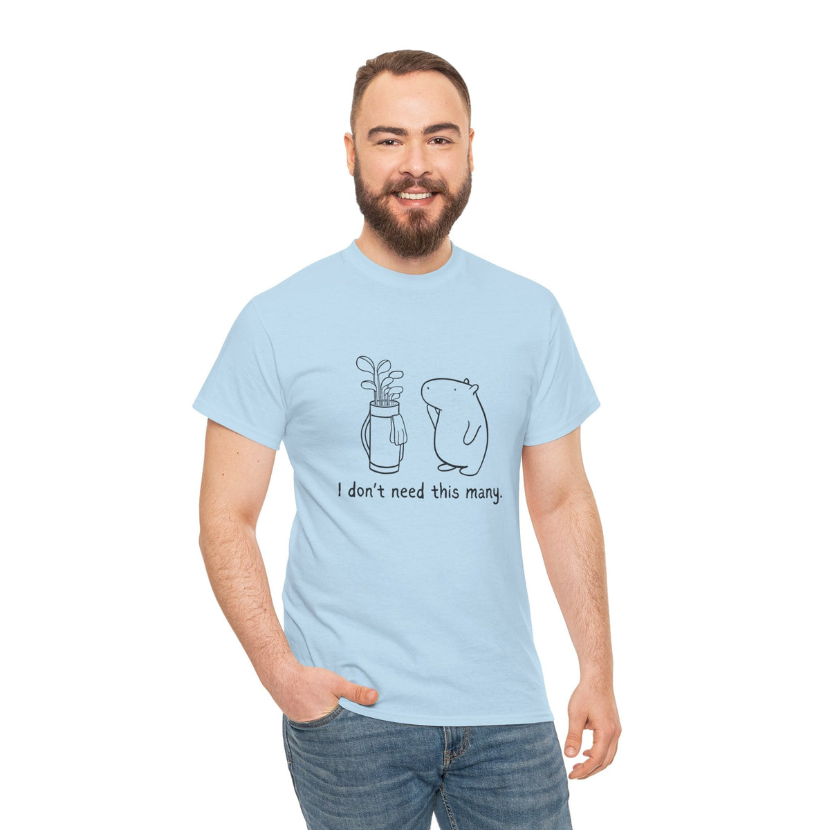 Capy Life light blue heavy cotton t-shirt featuring a minimalist capybara golf graphic and text on a smiling man.