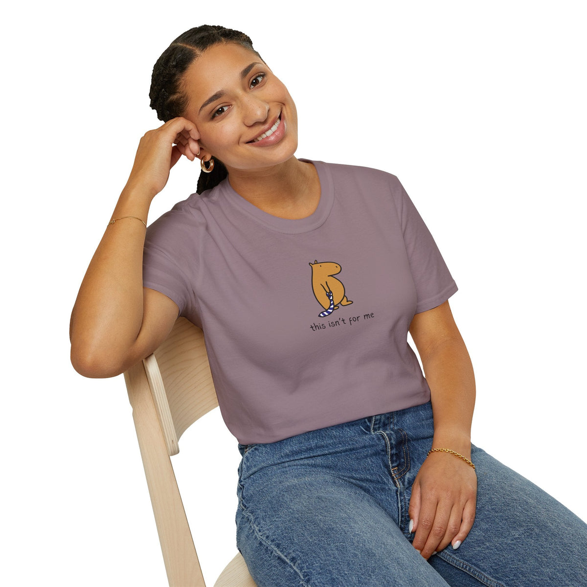 A woman wearing a Capy Life mauve heavyweight cotton t-shirt with a hand-drawn capybara graphic and text.