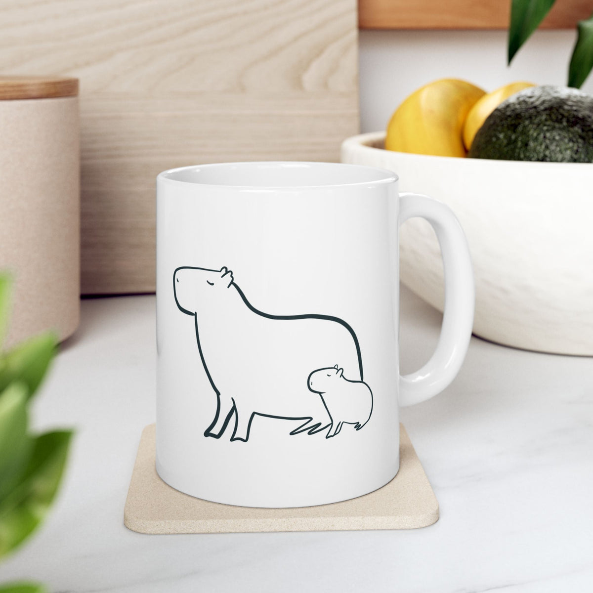 Capy Life white ceramic mug featuring a minimalist line art illustration of a mother capybara and her baby.
