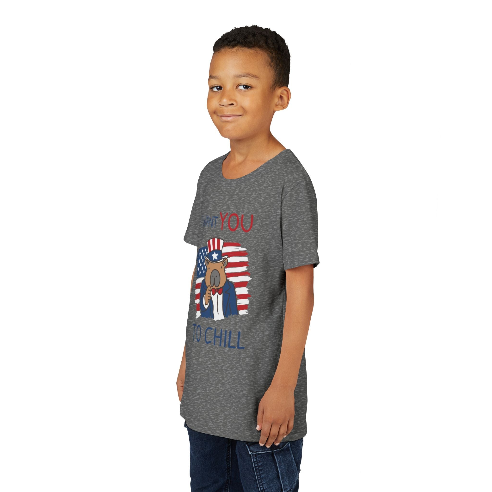 Young boy wearing a Capy Life grey heather t-shirt with a patriotic capybara graphic and I Want You To Chill text