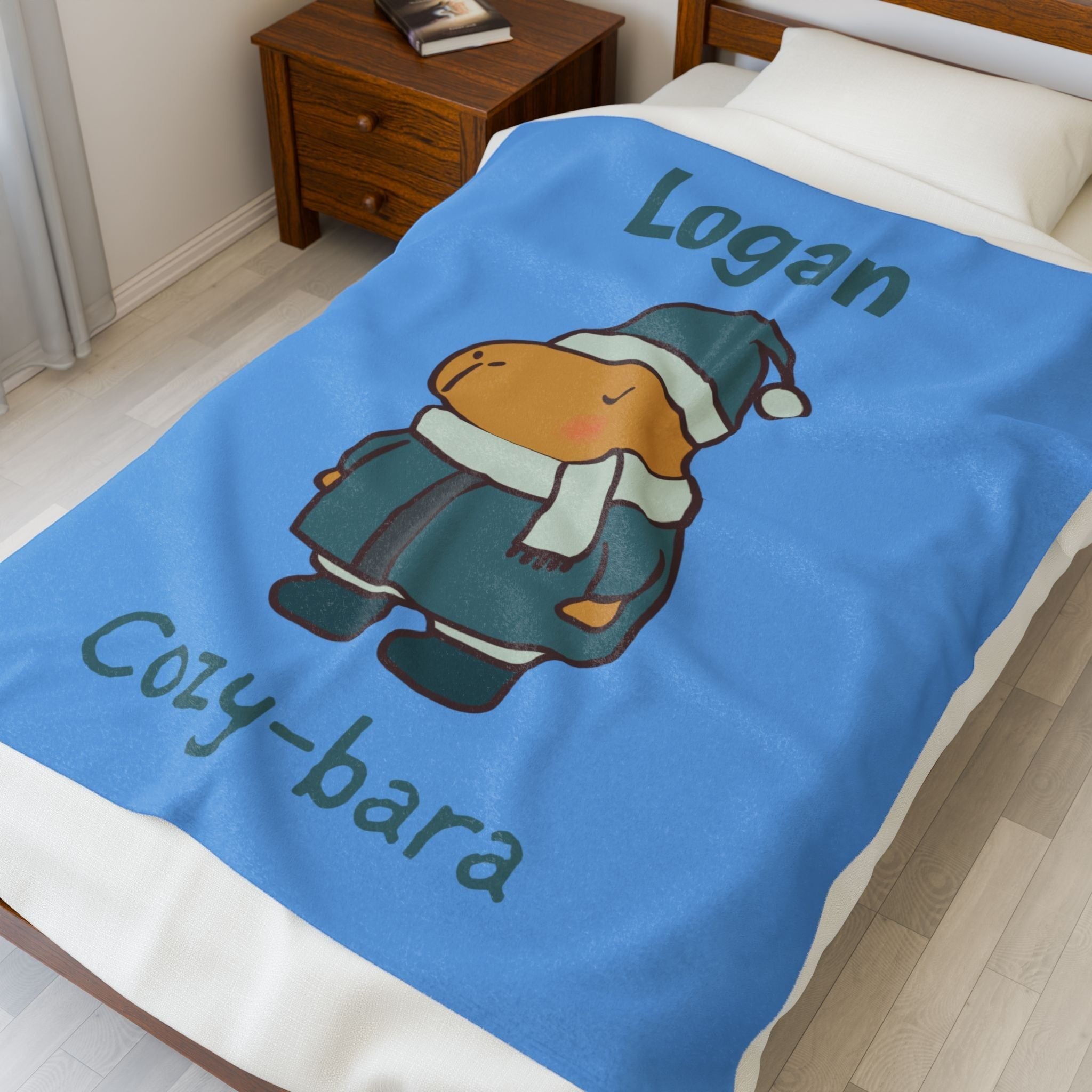 Capy Life personalized blue fleece blanket for kids featuring a cute winter capybara illustration and custom name.