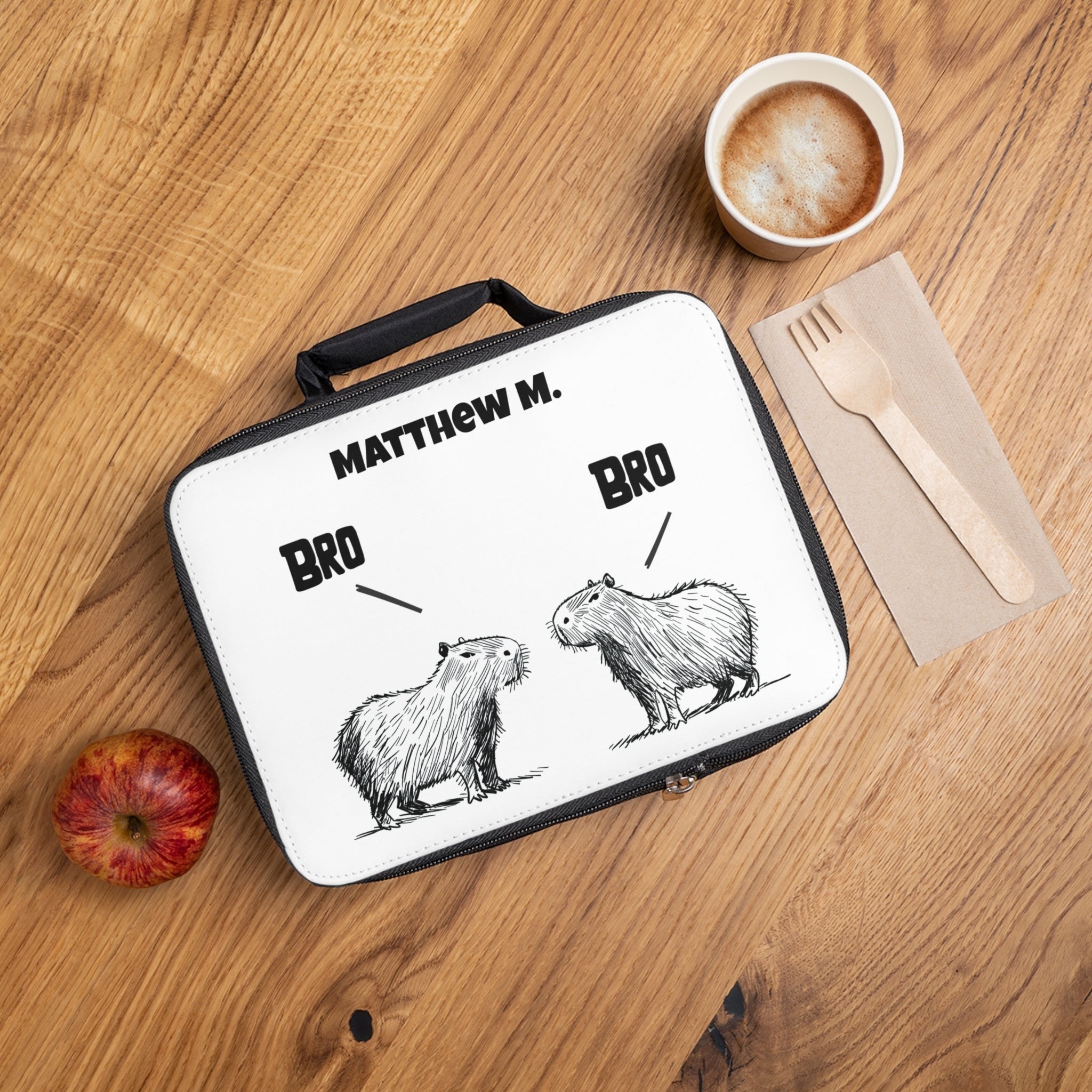 Capy Life personalized kids lunchbox featuring a hand-drawn capybara illustration and custom name on a white surface.