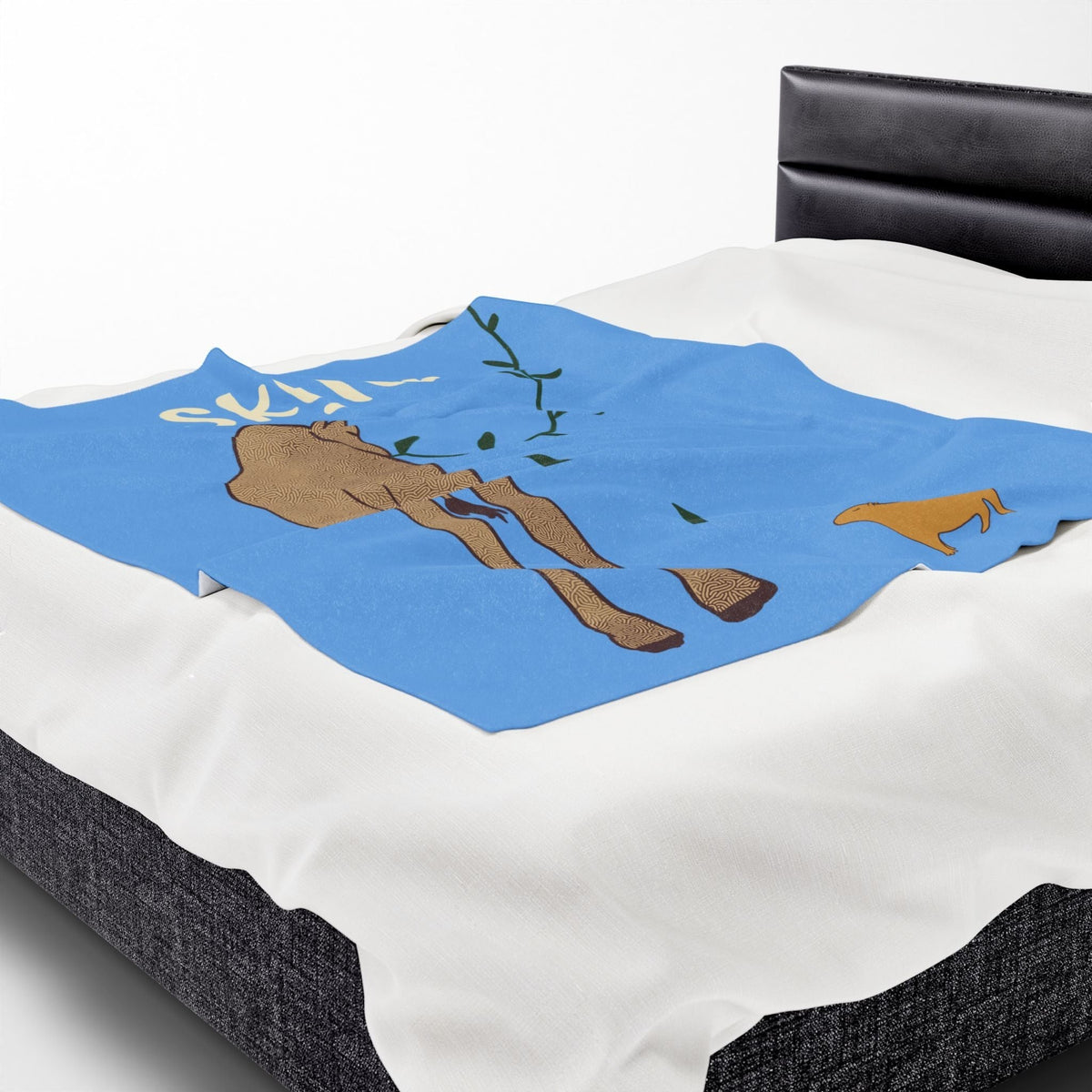 Capy Life personalized baby blanket featuring a giraffe and capybara on a blue background, draped over a bed.