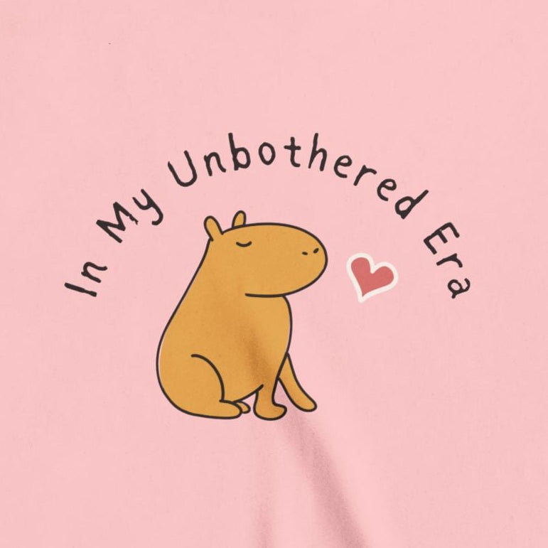 Capy Life kids t-shirt in soft pink featuring a cute capybara illustration and the text In My Unbothered Era