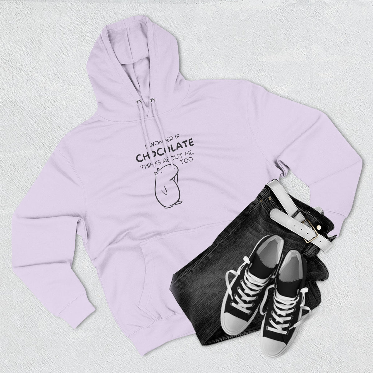 Capy Life premium light purple hoodie featuring Gene the Capybara line art and chocolate quote with jeans and sneakers
