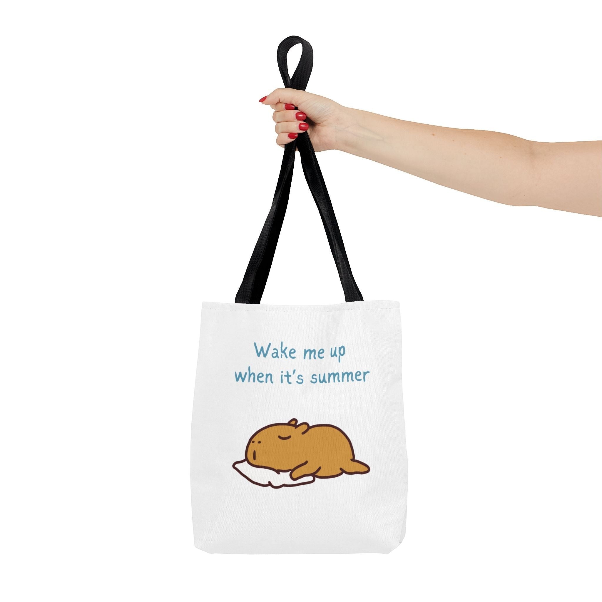 Capy Life white canvas tote bag featuring a sleepy capybara illustration and the text Wake me up when it's summer