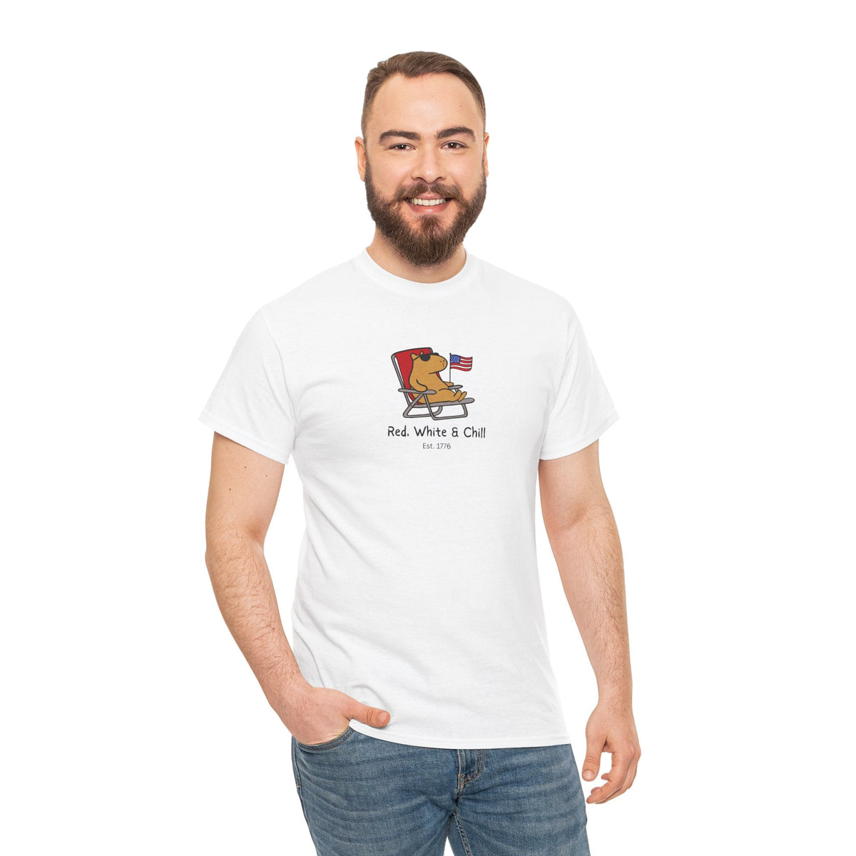 A man wearing a white Capy Life t-shirt featuring a graphic of a capybara lounging in a chair with an American flag.