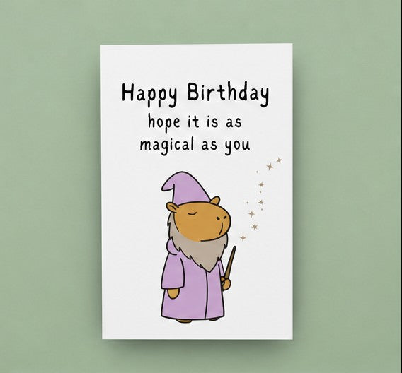 Capy Life birthday card featuring a cute capybara in a purple wizard robe and hat casting a spell with a wand