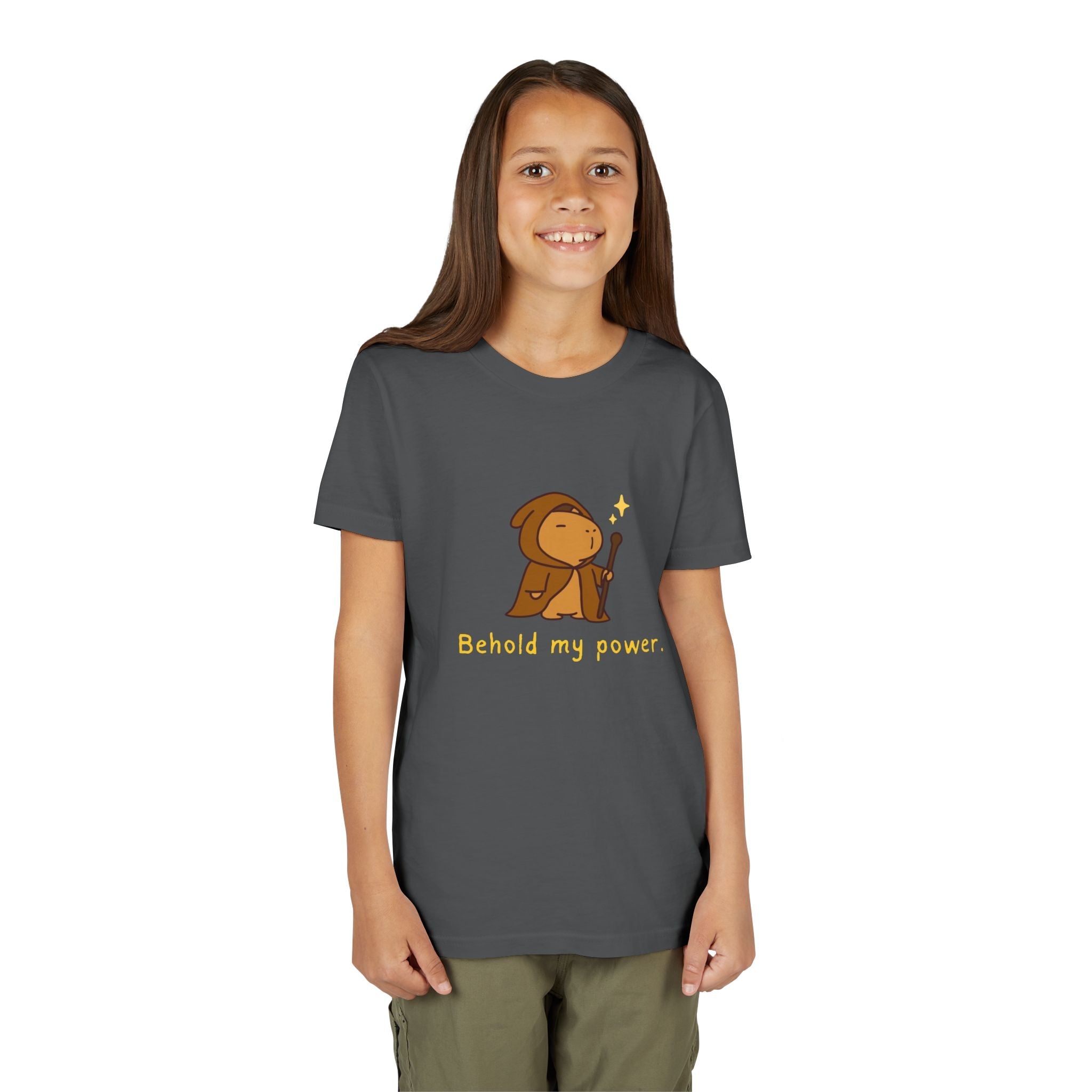 Girl wearing a dark grey Capy Life kids t-shirt featuring a cute wizard capybara graphic and Behold my power text