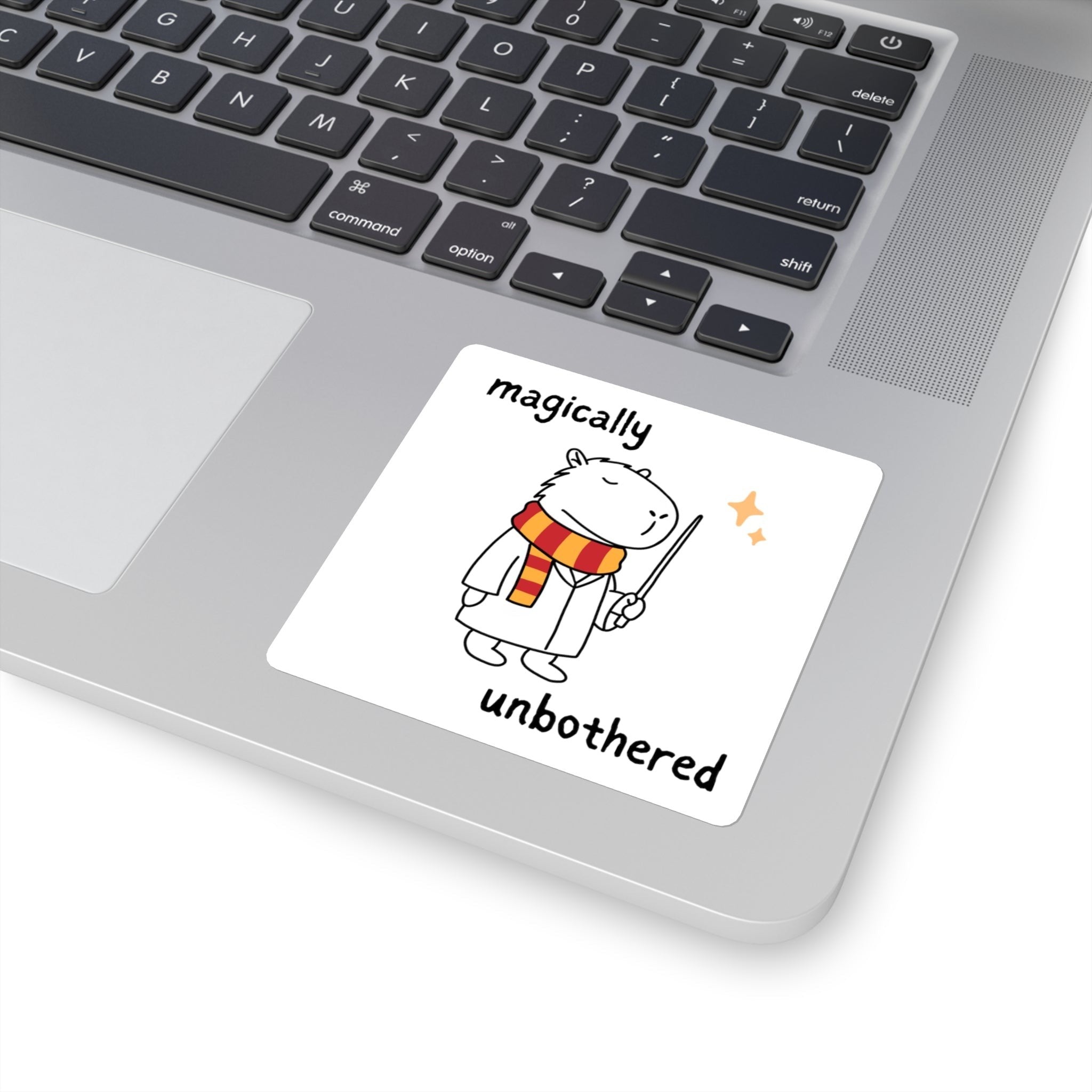 Capy Life vinyl sticker of a wizard capybara in robes and a striped scarf on a laptop with Magically Unbothered text.
