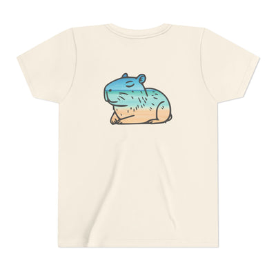 Unisex youth t-shirt featuring a cute, smiling cartoon capybara in a beach scene with blue water and sand.