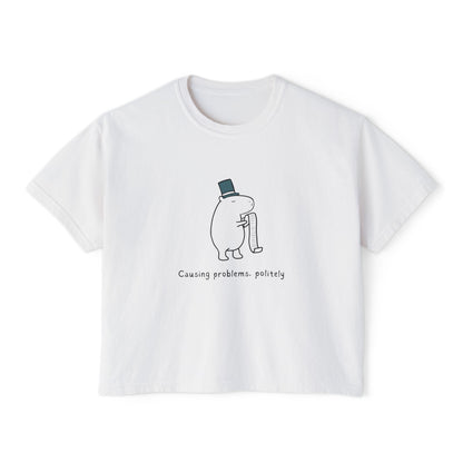 White boxy t-shirt with cartoon capybara illustration and text "Causing problems, politely
