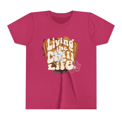 Unisex youth t-shirt in pink color with colorful text "Living the Chill Life" and an illustration of a baseball or softball glove.