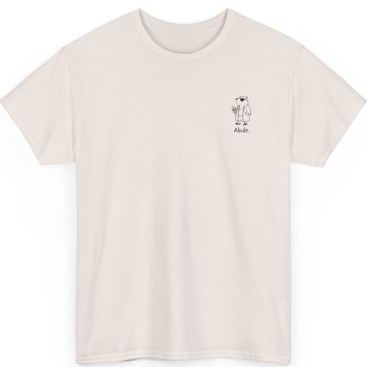 Beige t-shirt with capybara dude design and the text "Abide" on a white background