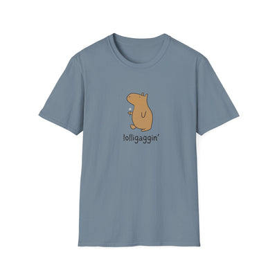 A light blue-gray short-sleeve crewneck t-shirt featuring a cartoon capybara holding a dandelion with the text 'lolligaggin'' printed below it, displayed on a solid white background.