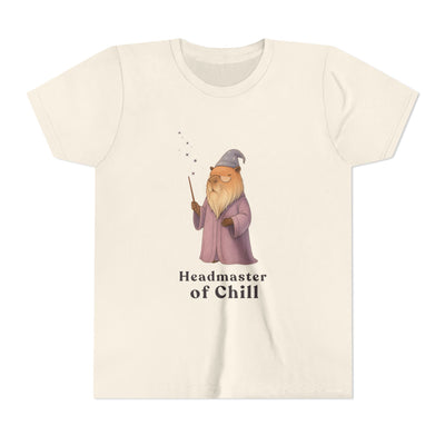 Cream-colored t-shirt with a whimsical illustration of a wizard-like capybara holding a magic wand, accompanied by the text "Headmaster of Chill".