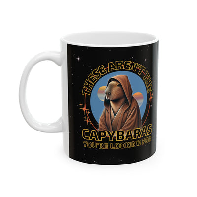 Ceramic mug with a whimsical space-themed design and a capybara character in a hooded robe against a starry night background.