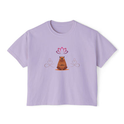 Purple boxy women's t-shirt with a cartoon bear illustration and lotus flower design.
