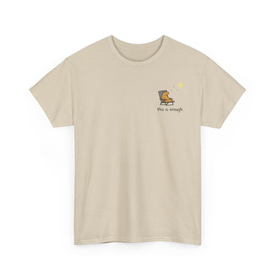 Tan colored shirt with a capybara in a lawn chair and the phrase "this is enough." in a left logo design.