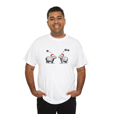 Man wearing a white short-sleeve crewneck t-shirt featuring a graphic of two fluffy capybara wearing red Santa hats, with 'Ho Ho Ho' text above them,
