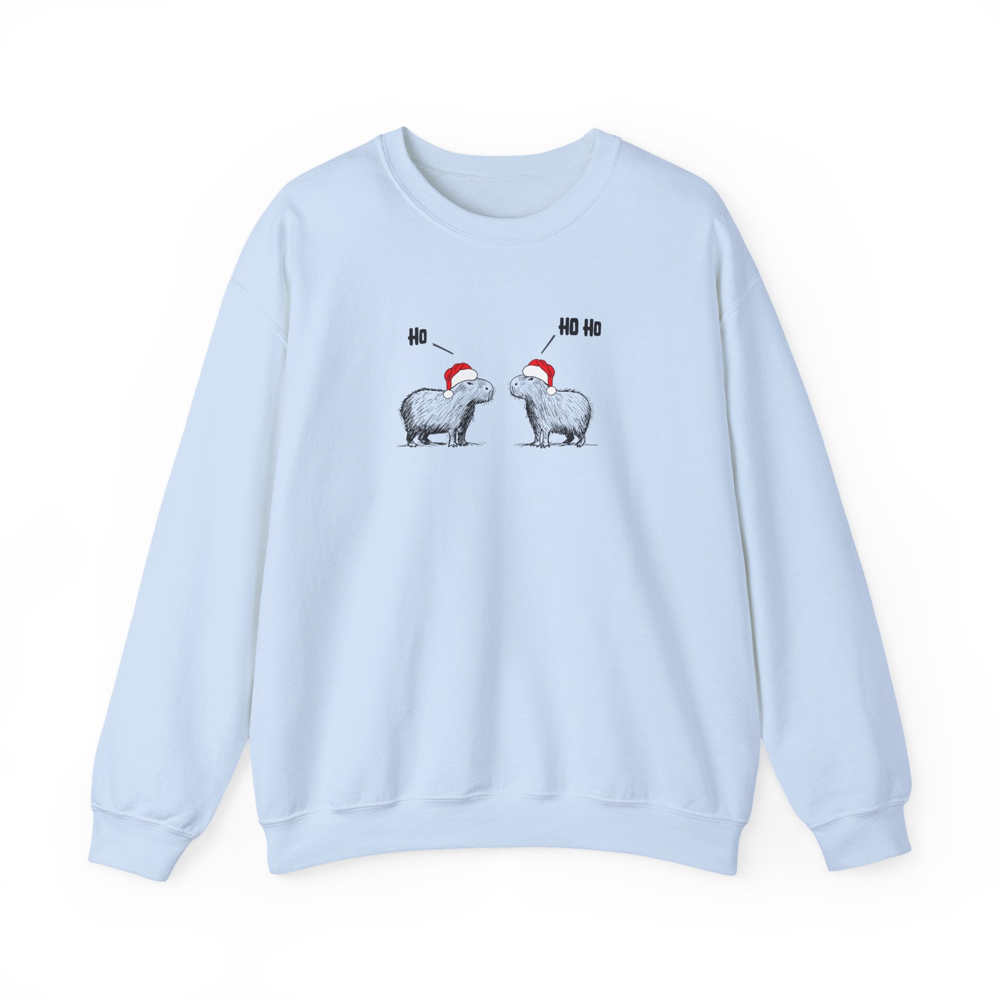 A light blue crewneck sweatshirt featuring a graphic of two capybaras wearing red Santa hats facing each other with 'HO HO HO' text above them, displayed on a clean white background.