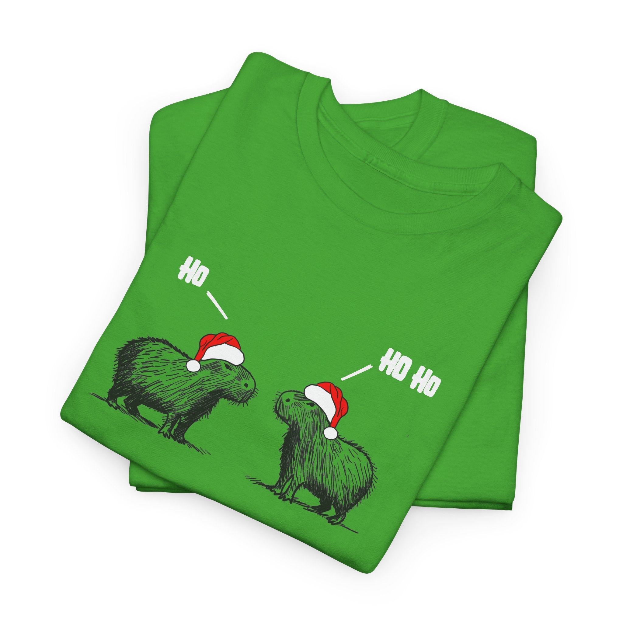 A folded bright green t-shirt featuring a humorous graphic of two capybara animals wearing red Santa hats, with speech bubbles reading 'HO' and 'HO HO'.