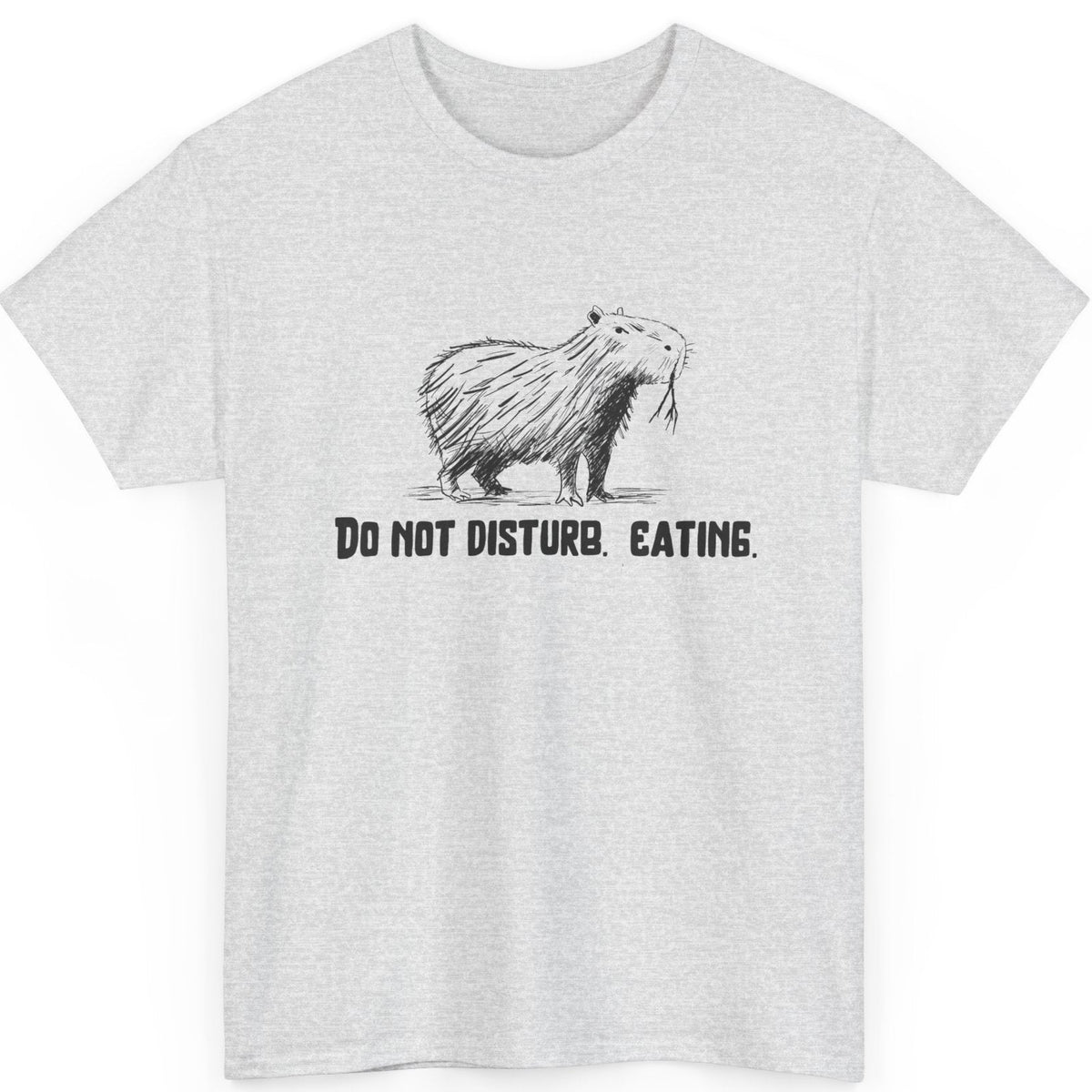 White t-shirt with a graphic of a capybara and text 'Do Not Disturb. Eating' on a white background