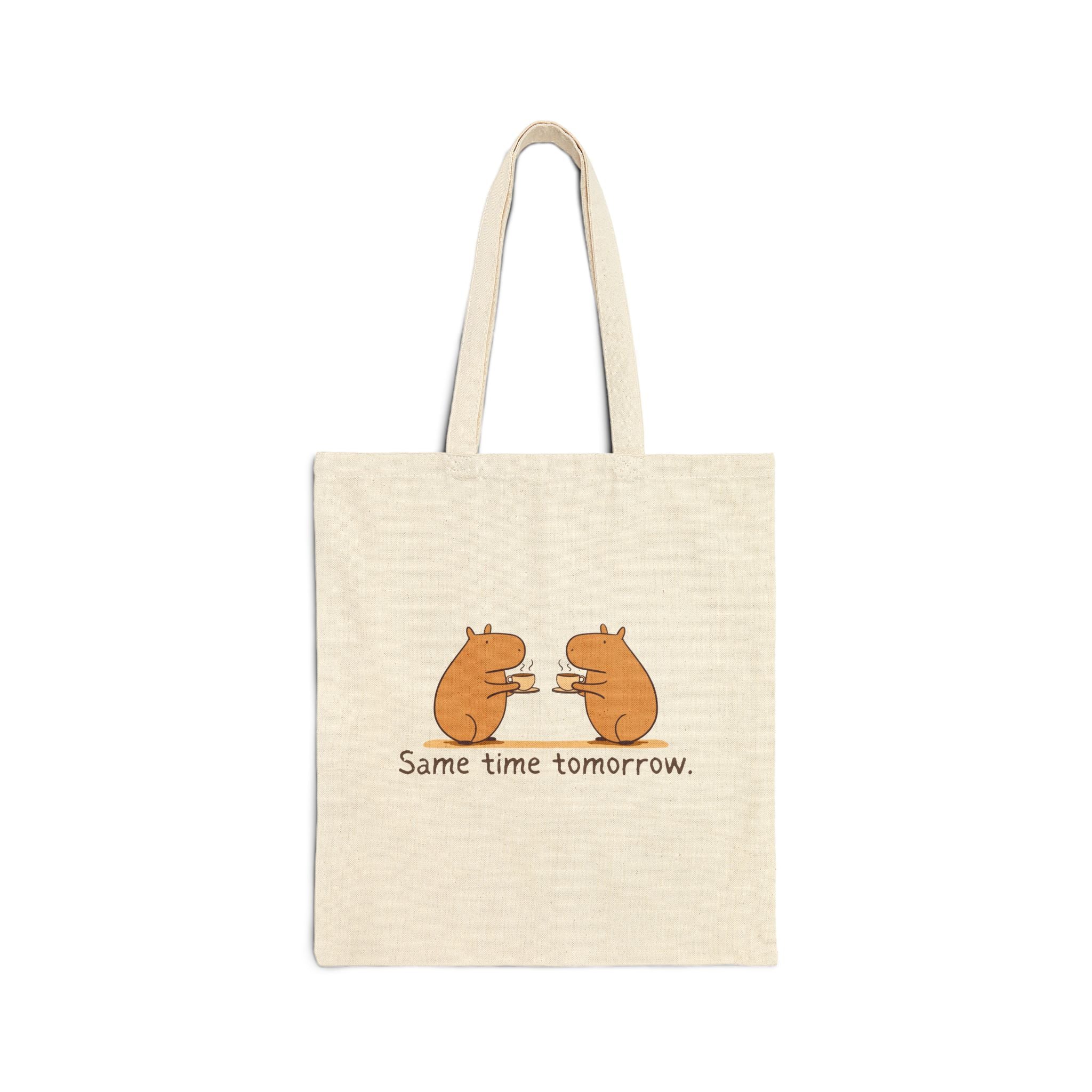 Beige tote bag with two capybara friends drinking coffee and the text "same time tomorrow"