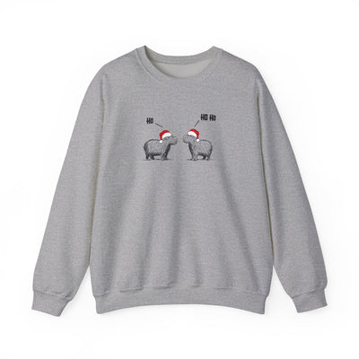 Gray crewneck sweatshirt featuring a graphic of two capybaras wearing red Santa hats facing each other with 'HO HO HO' text above them