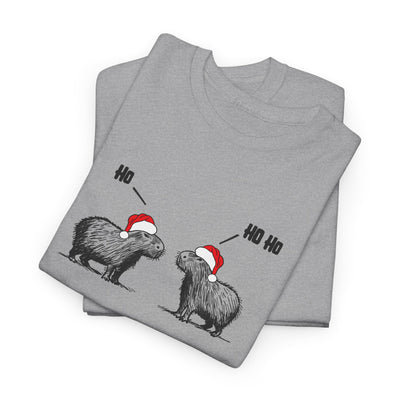 A folded heather gray t-shirt featuring a graphic of two capybara animals wearing red and white Santa hats, with 'HO' and 'HO HO' text above them, displayed on a clean white background.