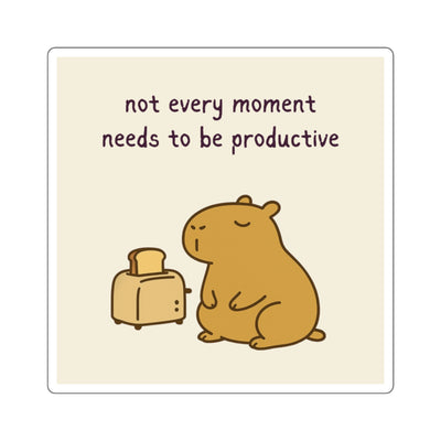 Cute cartoon capybara sitting next to toaster with text "not every moment needs to be productive" - Motivational vinyl sticker.