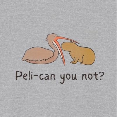 Close up of a gray t-shirt with a pelican attempting to eat a capybara and the humorous text "peli-can you not?" on it 